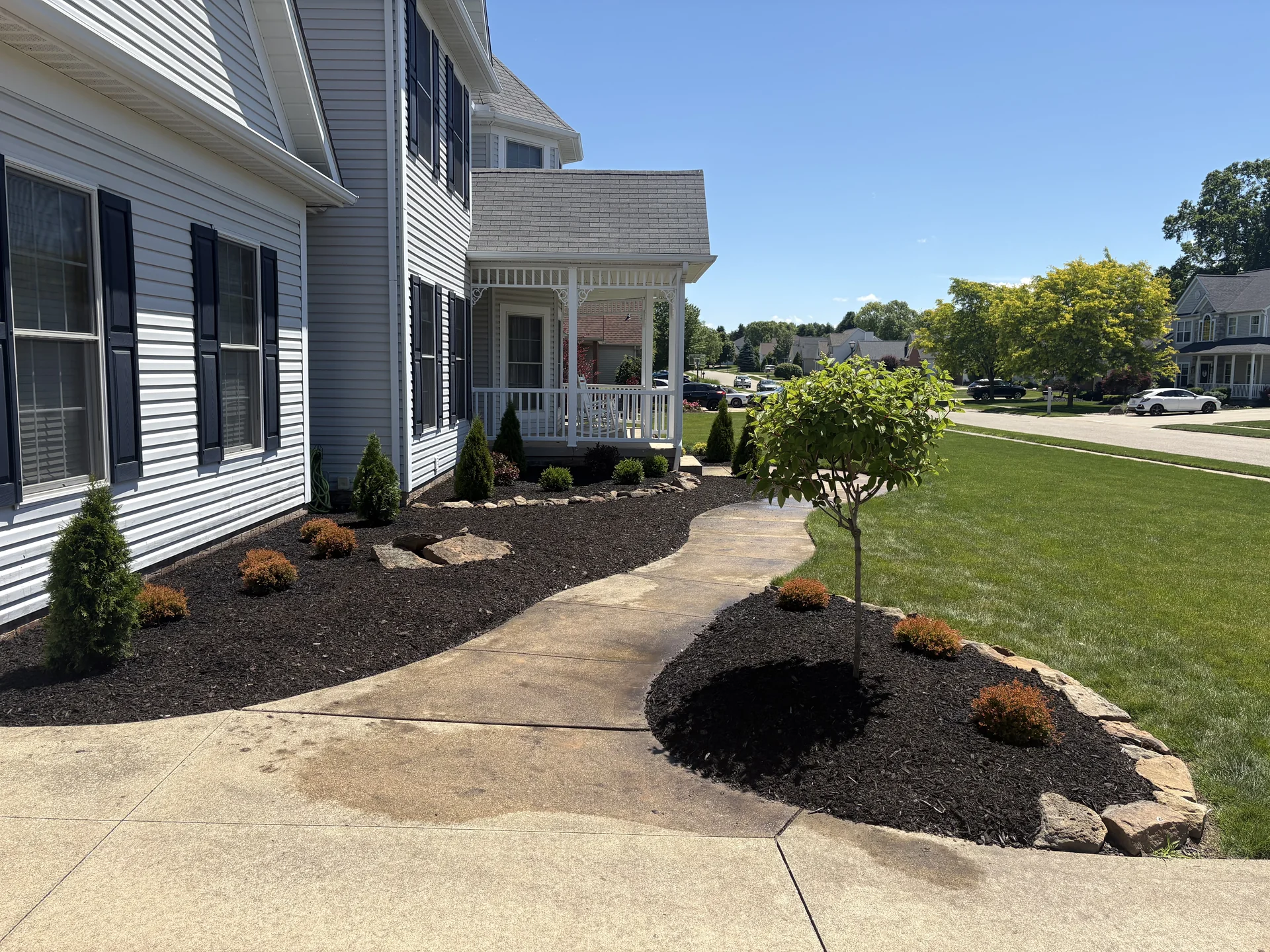 Landscape design with mulch, stone, and plants