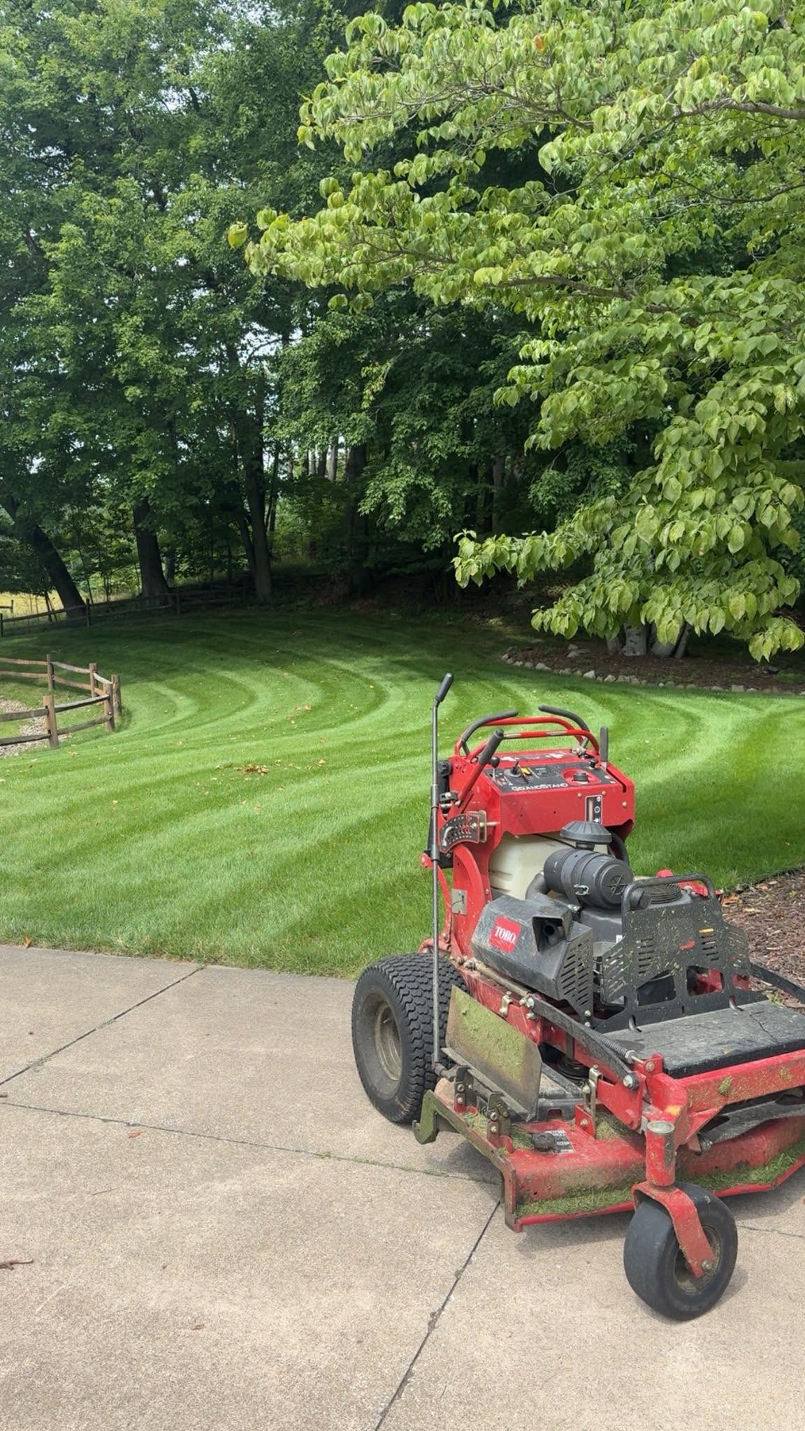 Commercial mower on striped lawn